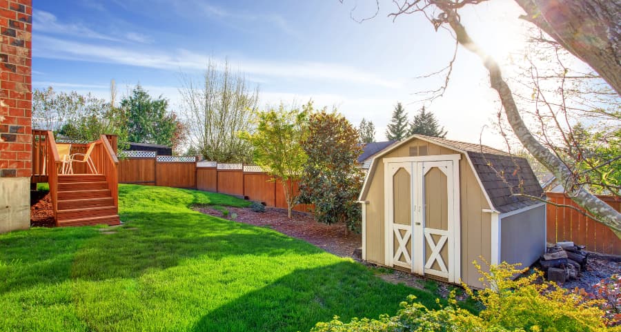 Fenced backyard with storage shed in Yakima